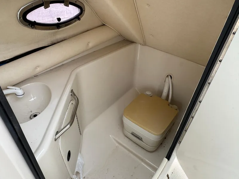Slide: The Image of 2001 Sea Ray 240 Sundeck boat interior with compact bathroom and sink. - 12