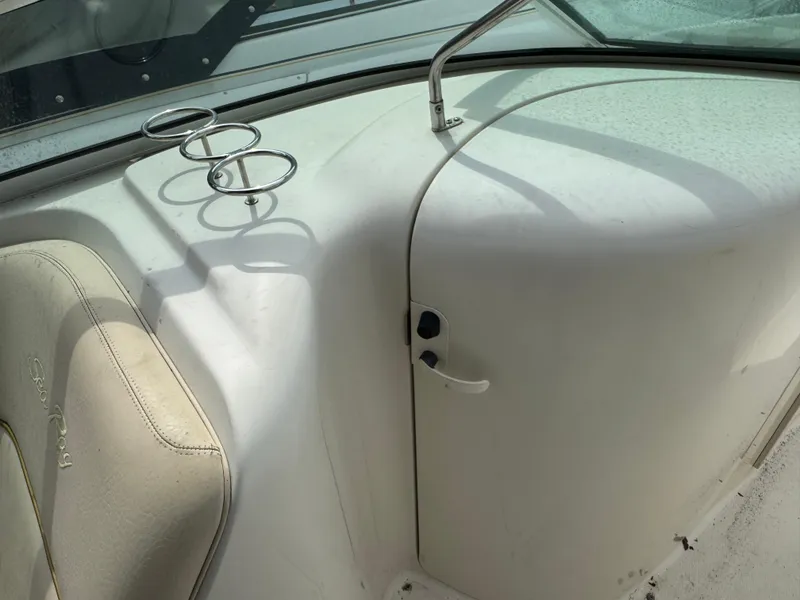 Slide: The Image of 2001 Sea Ray 240 Sundeck interior with cup holders and seating. - 18