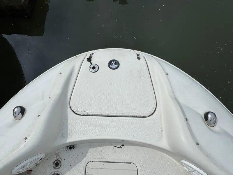 Slide: The Image of 2001 Sea Ray 240 Sundeck boat deck, featuring storage hatch and fittings. - 19