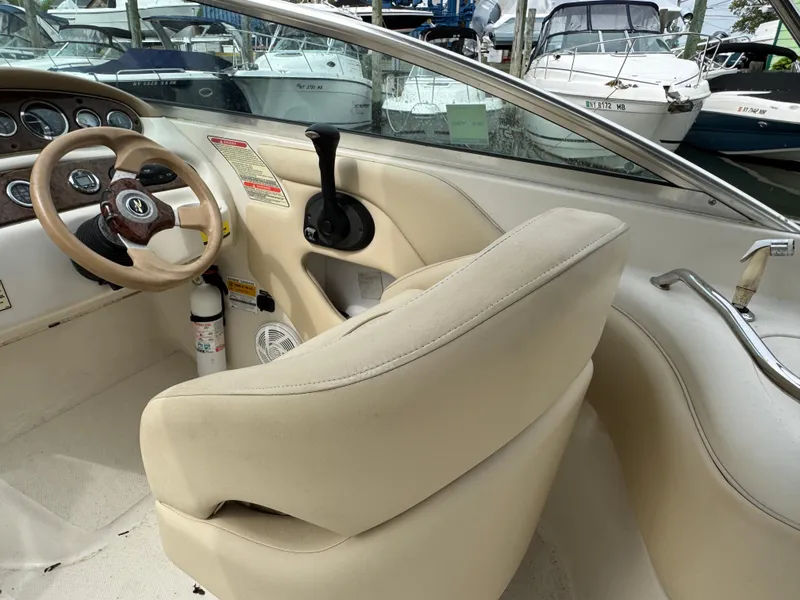 Slide: The Image of 2001 Sea Ray 240 Sundeck boat interior with steering wheel and control panel. - 7