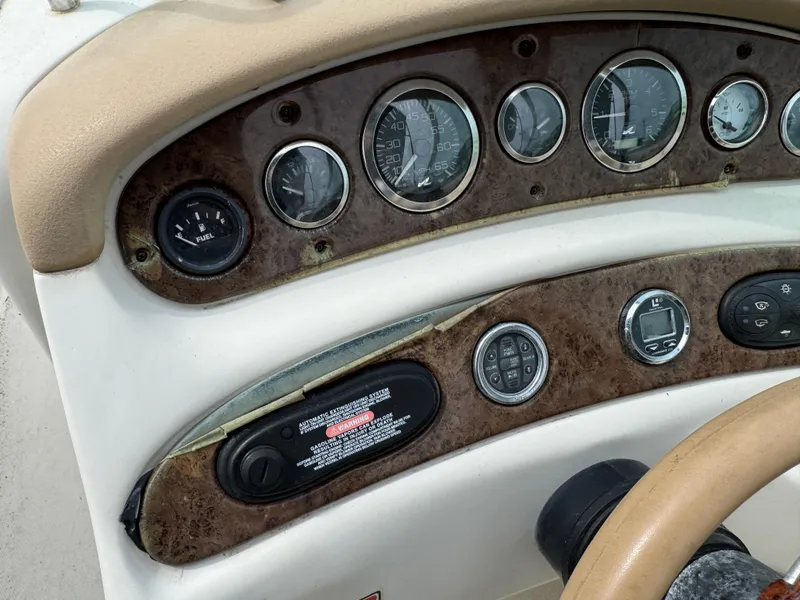 Slide: The Image of Dashboard of a 2001 Sea Ray 240 Sundeck boat with gauges and controls. - 8