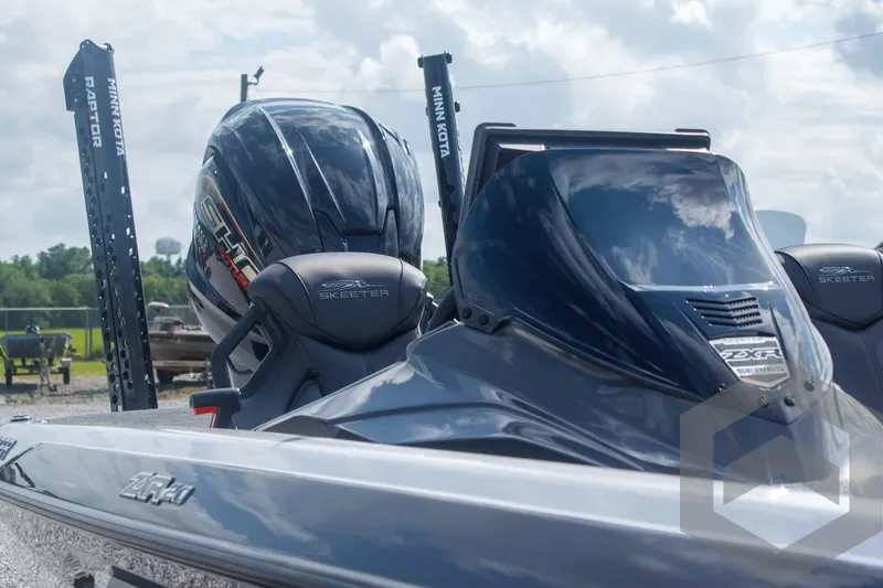 Slide: The Image of 2025 Skeeter ZXR 20 boat with sleek design and powerful engine, outdoors under cloudy sky. - 17