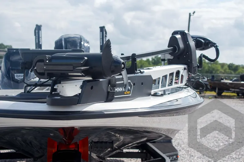 Slide: The Image of 2025 Skeeter ZXR 20 boat with Minn Kota trolling motor, parked outdoors. - 18