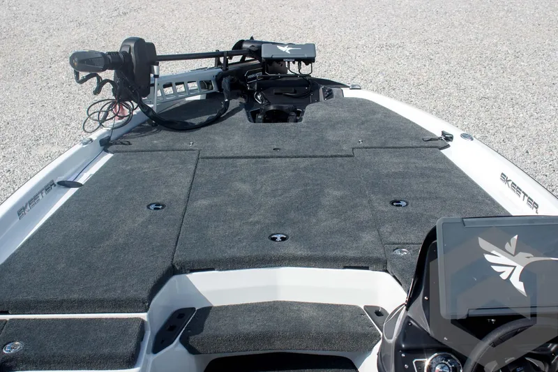 Slide: The Image of 2025 Skeeter ZXR 20 boat deck with trolling motor and carpeted surface. - 20