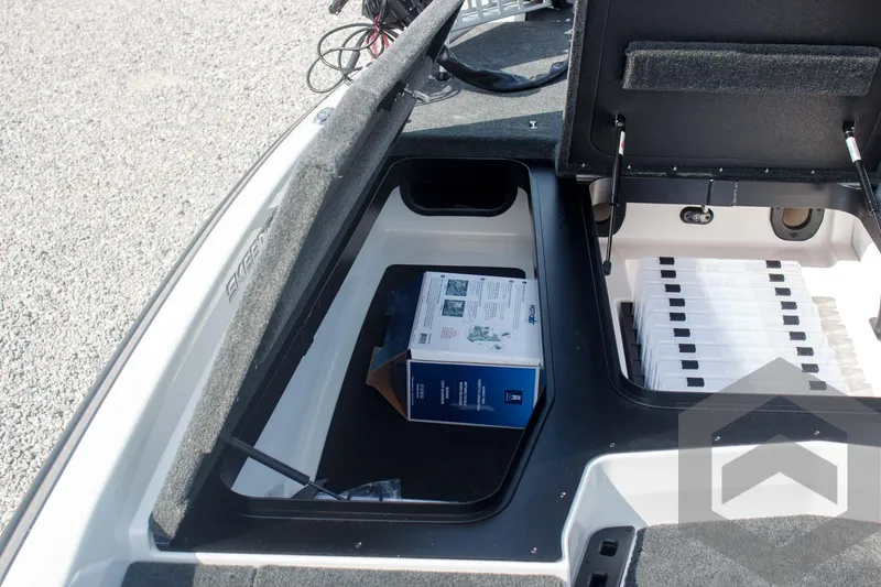 Slide: The Image of Open storage compartment of 2025 Skeeter ZXR 20 boat with a box inside. - 22