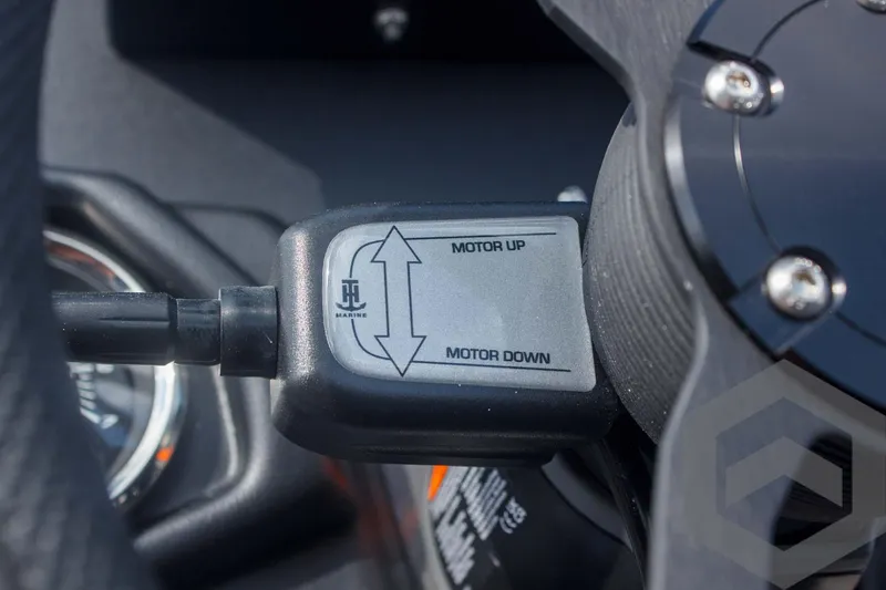 Slide: The Image of Close-up of Skeeter ZXR 20 motor control switch, labeled "Motor Up" and "Motor Down." - 38