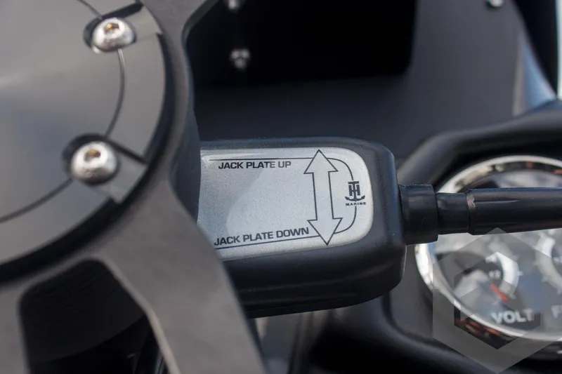 Slide: The Image of Close-up of Skeeter ZXR 20 jack plate control, 2025 model, with gauge in background. - 39