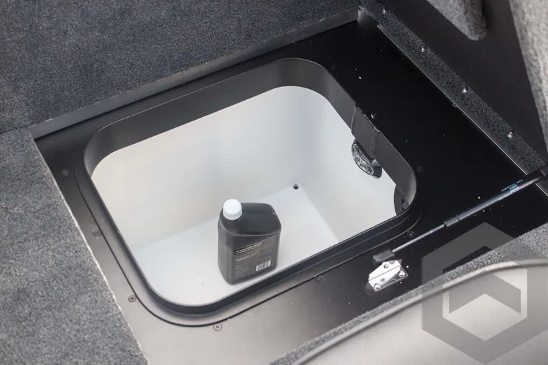 Slide: The Image of Storage compartment in 2025 Skeeter ZXR 20 boat, featuring a bottle of oil. - 42