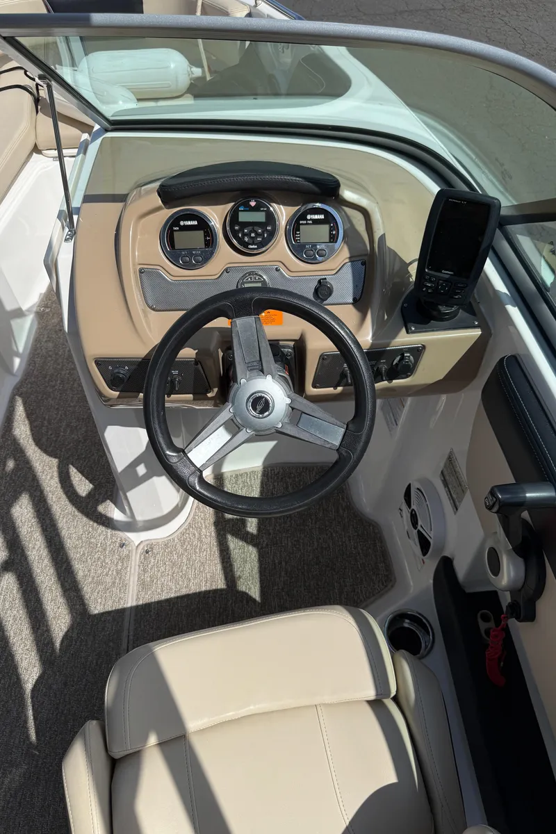 Slide: The Image of 2018 Chaparral 21 Deluxe H20 Ski and Fish boat dashboard with steering wheel and gauges. - 10