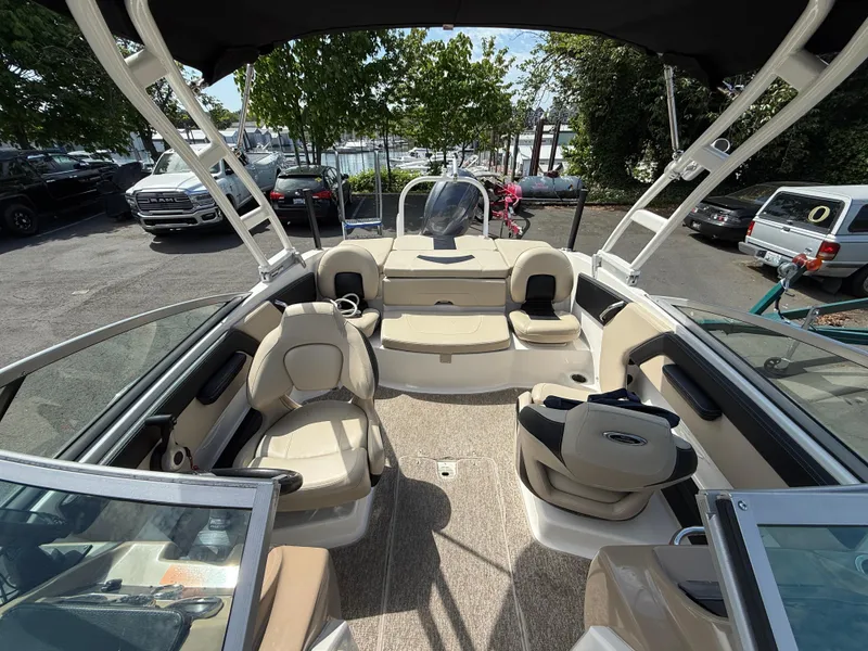 Slide: The Image of 2018 Chaparral 21 Deluxe H20 Ski and Fish boat interior with seating and steering wheel. - 12