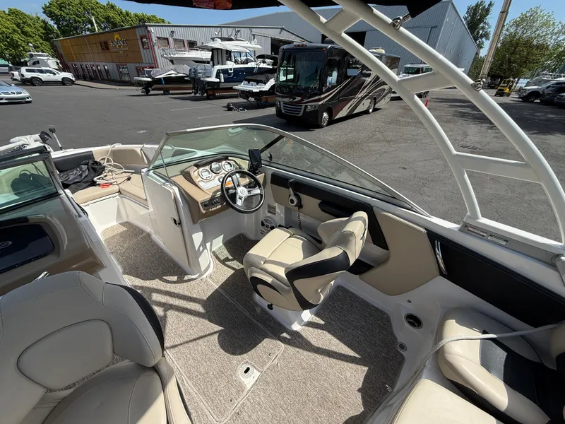 Slide: The Image of 2018 Chaparral 21 Deluxe H20 Ski and Fish boat interior with steering wheel and seating. - 7