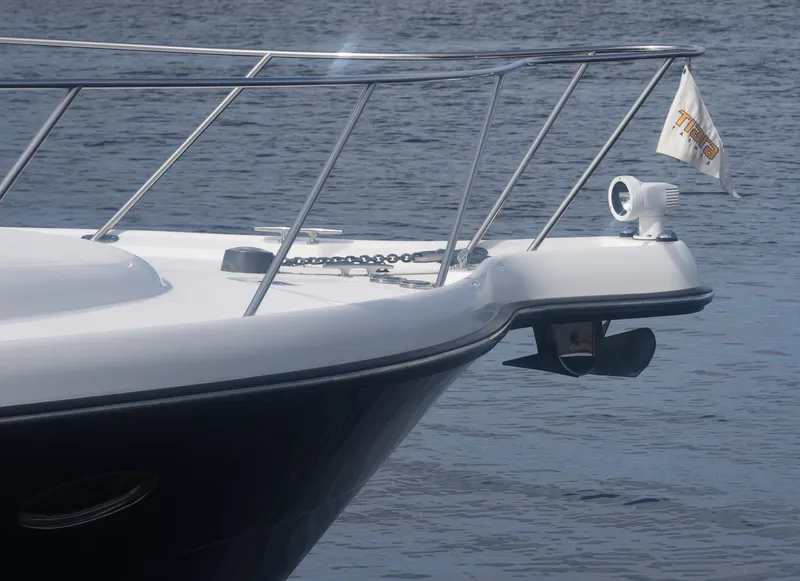 Slide: The Image of 2006 Tiara Yachts 36 Open boat bow with railing and flag on water. - 12