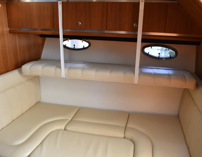Slide: The Image of 2006 Tiara Yachts 36 Open cabin interior with beige seating and wooden cabinets. - 13