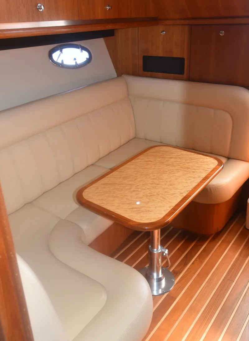 Slide: The Image of 2006 Tiara Yachts 36 Open interior with beige seating and wooden table. - 16