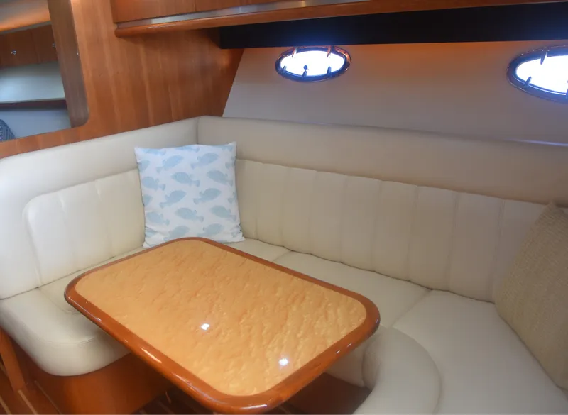 Slide: The Image of 2006 Tiara Yachts 36 Open interior with beige seating and wooden table. - 17