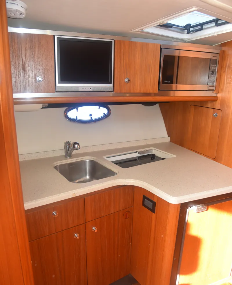 Slide: The Image of 2006 Tiara Yachts 36 Open kitchen with sink, microwave, and TV. - 19