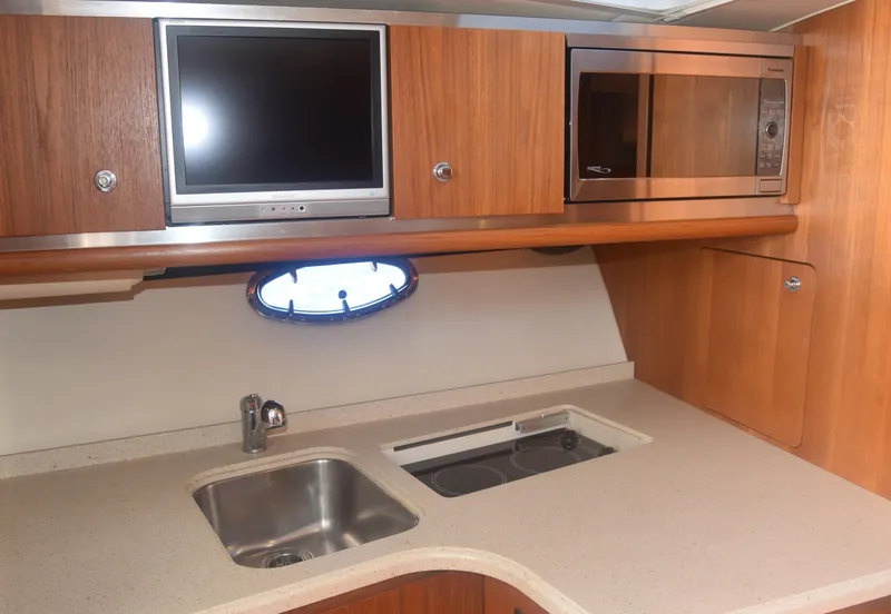Slide: The Image of 2006 Tiara Yachts 36 Open kitchen with sink, microwave, and TV. - 23