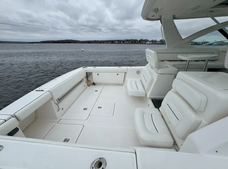 Slide: The Image of 2006 Tiara Yachts 36 Open with spacious deck, white seating, and scenic water view. - 27