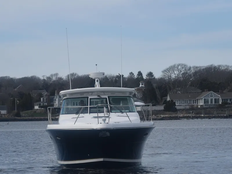 Slide: The Image of 2006 Tiara Yachts 36 Open on water, front view with coastal background. - 29