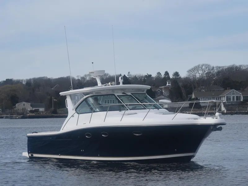 Slide: The Image of 2006 Tiara Yachts 36 Open boat on calm water, with coastal homes in the background. - 30