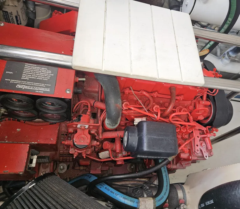 Slide: The Image of Engine compartment of a 2006 Tiara Yachts 36 Open, featuring a red engine block. - 34