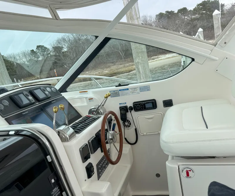 Slide: The Image of 2006 Tiara Yachts 36 Open helm with steering wheel and control panel. - 5