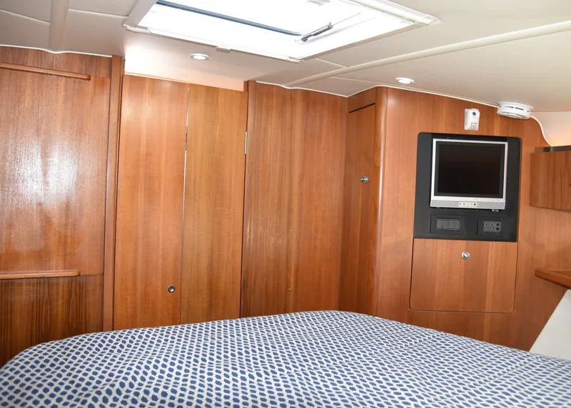 Slide: The Image of 2006 Tiara Yachts 36 Open cabin interior with wood paneling and TV. - 7