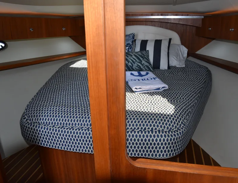 Slide: The Image of 2006 Tiara Yachts 36 Open cabin interior with cozy bed and wooden accents. - 9