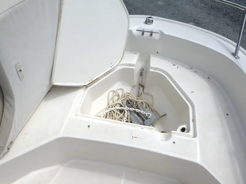 Slide: The Image of 2024 Boston Whaler 160 Super Sport anchor storage compartment with rope and anchor. - 9
