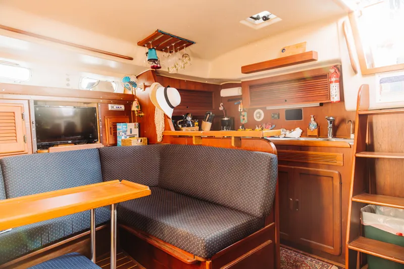 Slide: The Image of Interior of 1983 Morgan Out Island 41 sailboat with cozy seating and wooden cabinetry. - 12