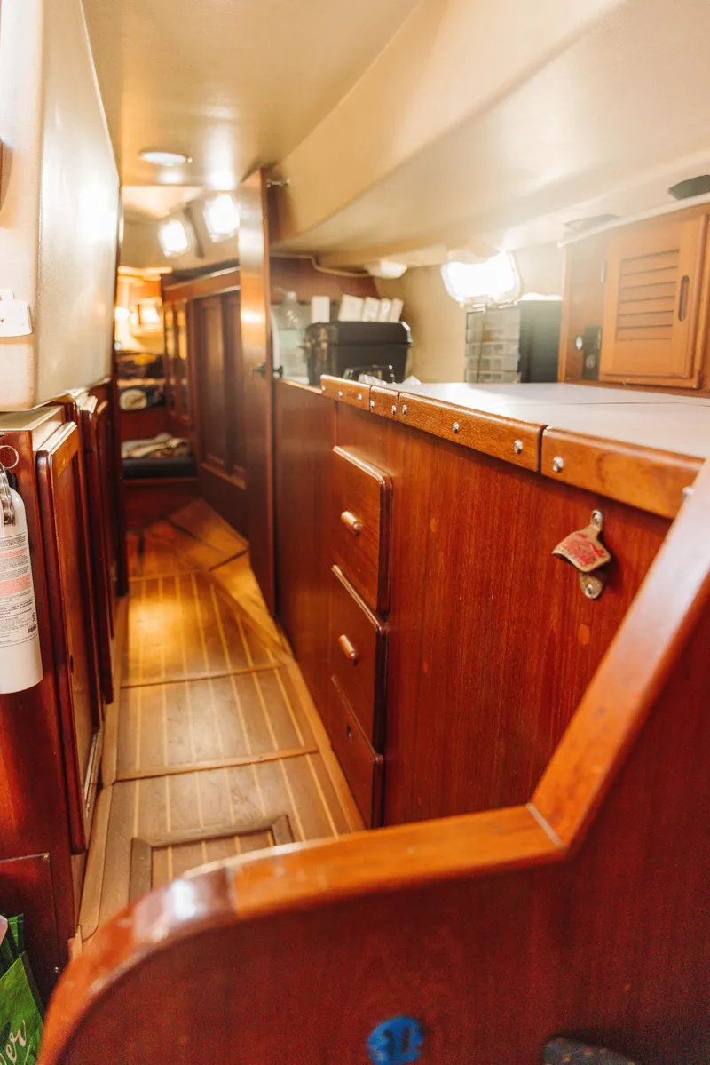 Slide: The Image of 1983 Morgan Out Island 41 yacht interior with wooden cabinetry and cozy hallway. - 13