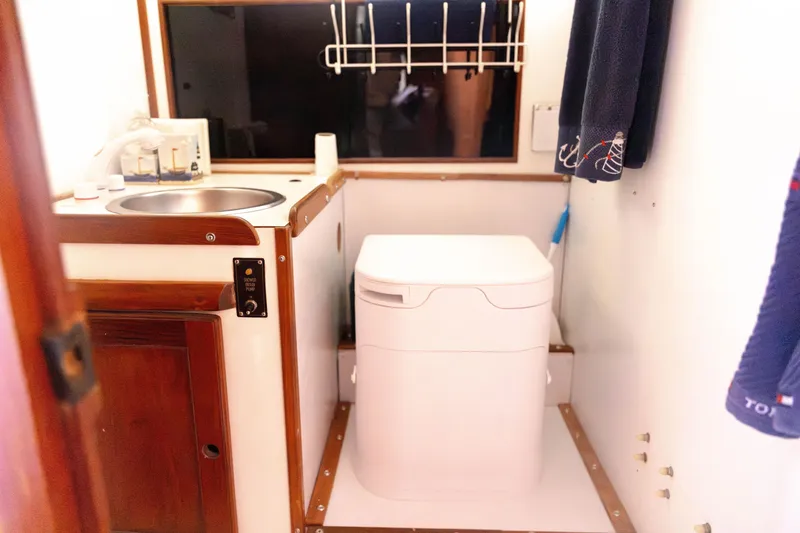Slide: The Image of 1983 Morgan Out Island 41 yacht bathroom with sink, toilet, and towel rack. - 20