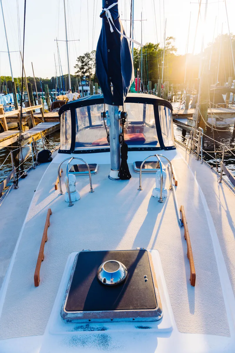 Slide: The Image of 1983 Morgan Out Island 41 sailboat docked at marina, sunlit deck view. - 28