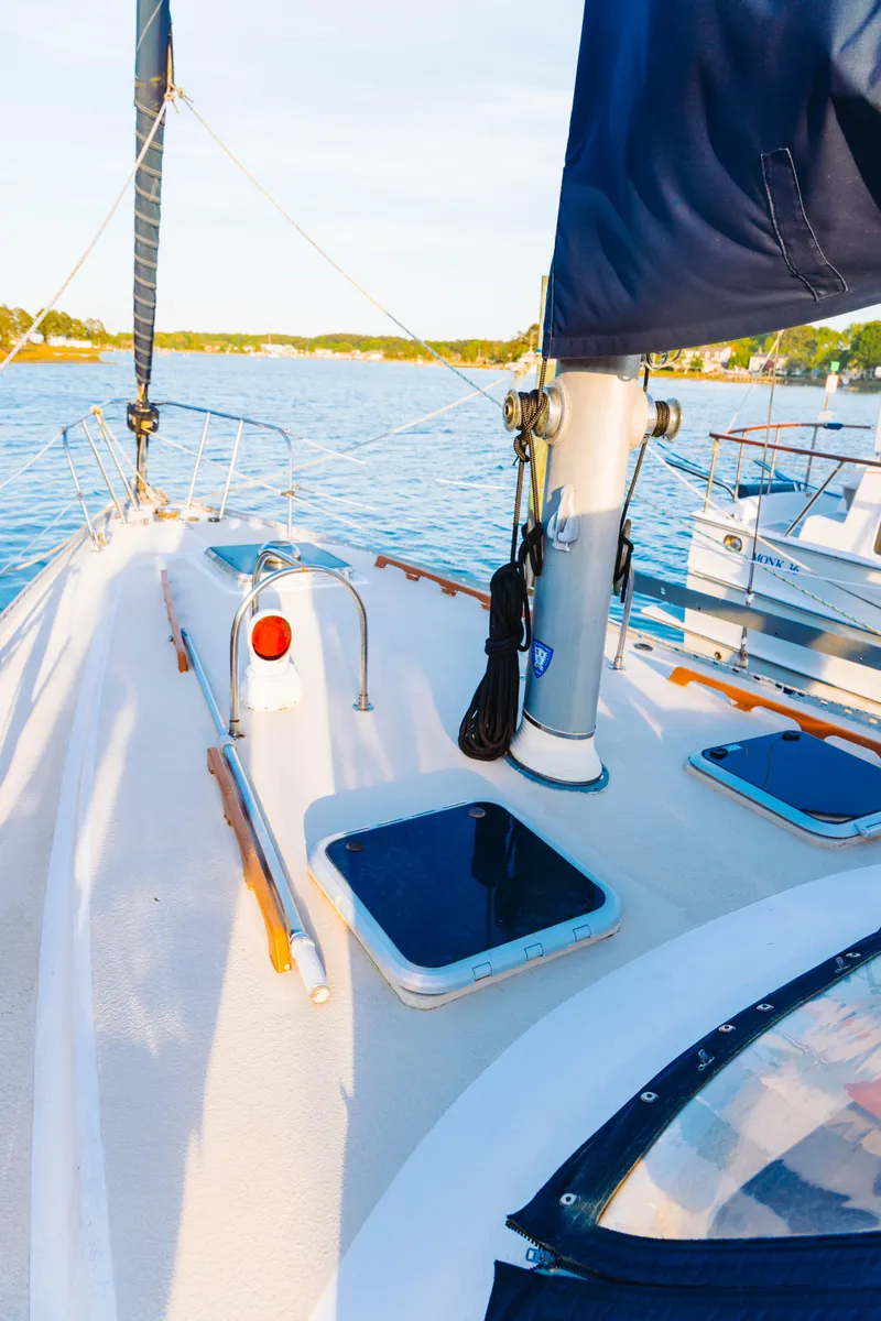 Slide: The Image of 1983 Morgan Out Island 41 sailboat deck with blue waters in the background. - 30