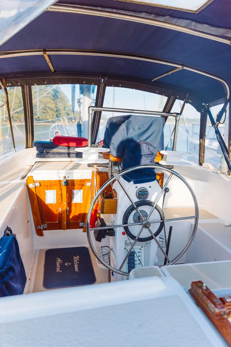 Slide: The Image of 1983 Morgan Out Island 41 sailboat cockpit with steering wheel and canopy. - 8