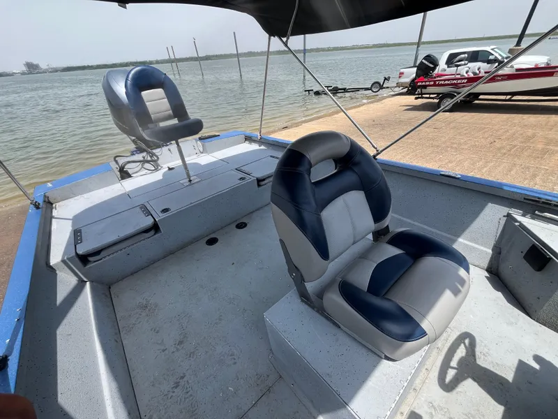 Slide: The Image of 2017 G3 20 CCJ DLX boat with blue and gray seating, docked by a lake. - 15