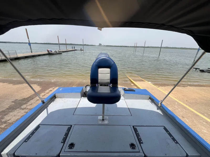 Slide: The Image of 2017 G3 20 CCJ DLX boat with blue seat, docked by a lake. - 20