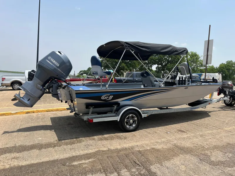 Slide: The Image of 2017 G3 20 CCJ DLX boat with Yamaha motor on trailer, parked outdoors. - 23