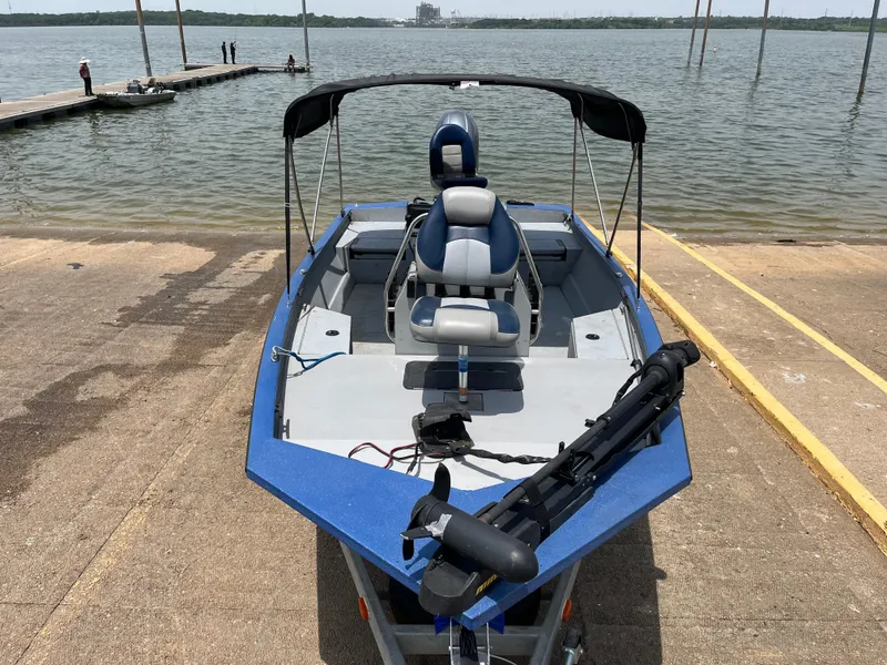 Slide: The Image of 2017 G3 20 CCJ DLX boat at dock, blue and gray interior, lake background. - 26