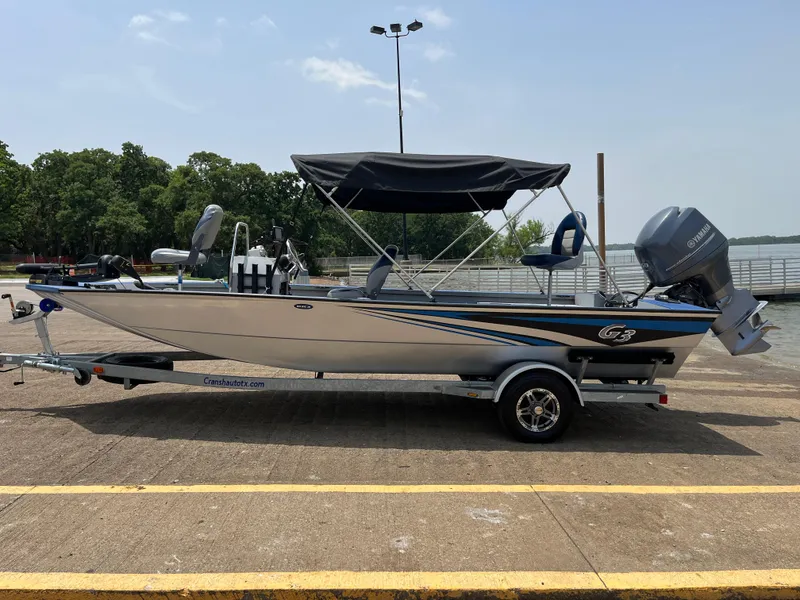 Slide: The Image of 2017 G3 20 CCJ DLX boat with canopy on trailer, parked outdoors. - 29