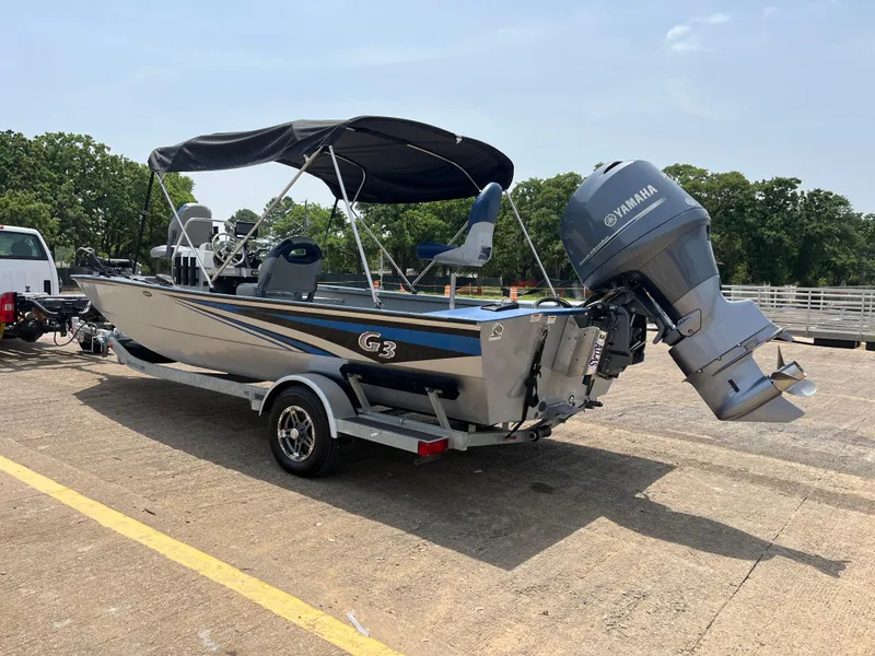 Slide: The Image of 2017 G3 20 CCJ DLX boat with Yamaha motor on trailer, parked outdoors. - 30