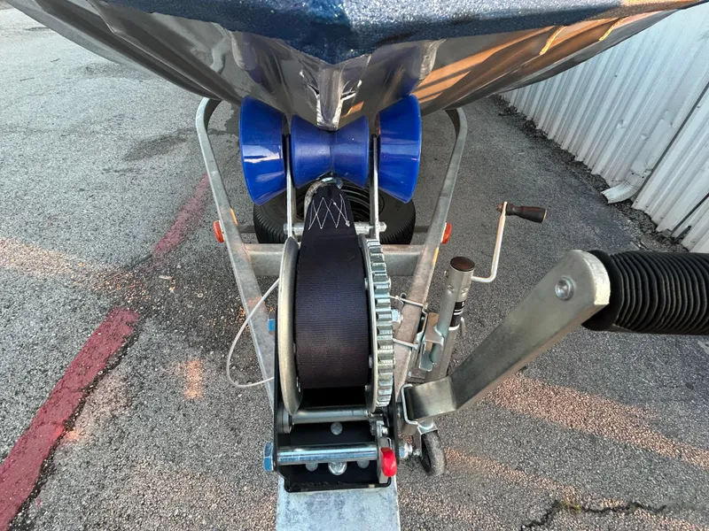 Slide: The Image of 2017 G3 20 CCJ DLX boat trailer with winch and blue rollers on asphalt. - 41