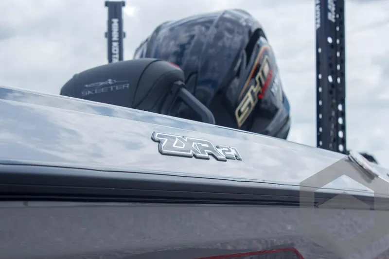 Slide: The Image of 2025 Skeeter ZXR 21 boat with sleek design and powerful engine, under cloudy sky. - 10