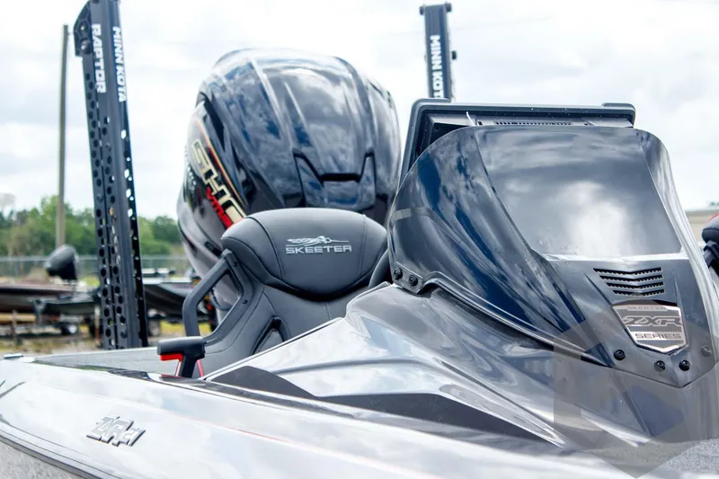 Slide: The Image of 2025 Skeeter ZXR 21 boat with sleek design and advanced features, showcased in a marina setting. - 17