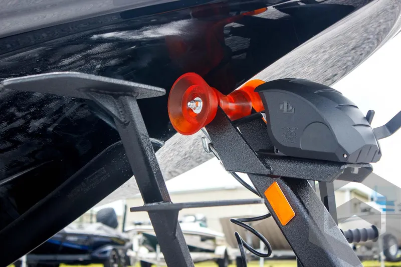 Slide: The Image of Skeeter ZXR 21 boat trailer hitch detail, 2025 model, featuring orange roller and black components. - 20