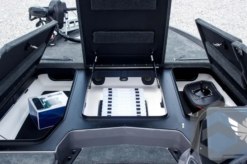 Slide: The Image of 2025 Skeeter ZXR 21 boat storage compartments with open lids and organized interior. - 22