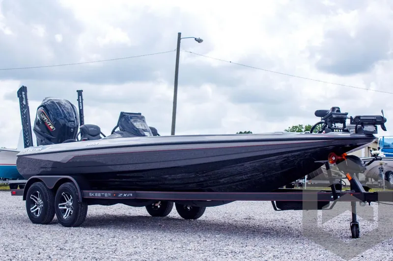 Slide: The Image of 2025 Skeeter ZXR 21 boat on trailer, parked outdoors under cloudy sky. - 3