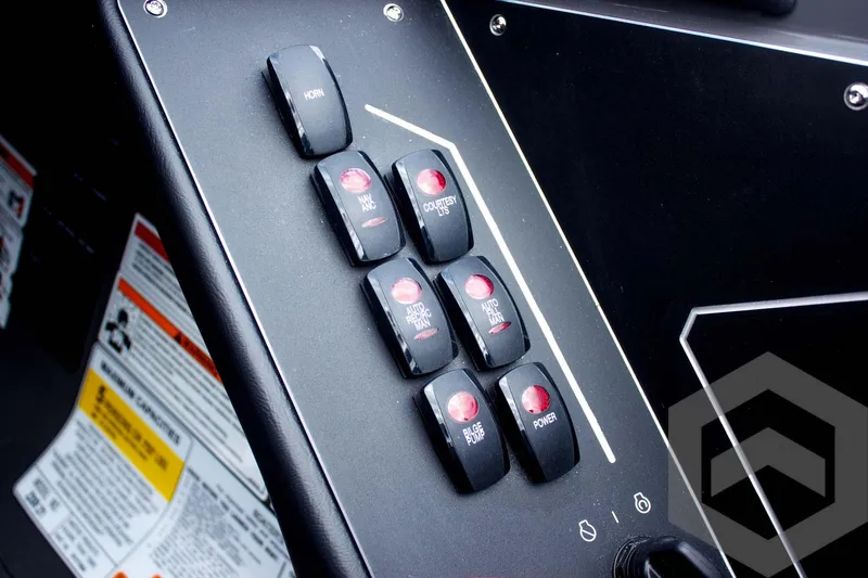 Slide: The Image of Control panel of 2025 Skeeter ZXR 21 boat with labeled switches and warning labels. - 34