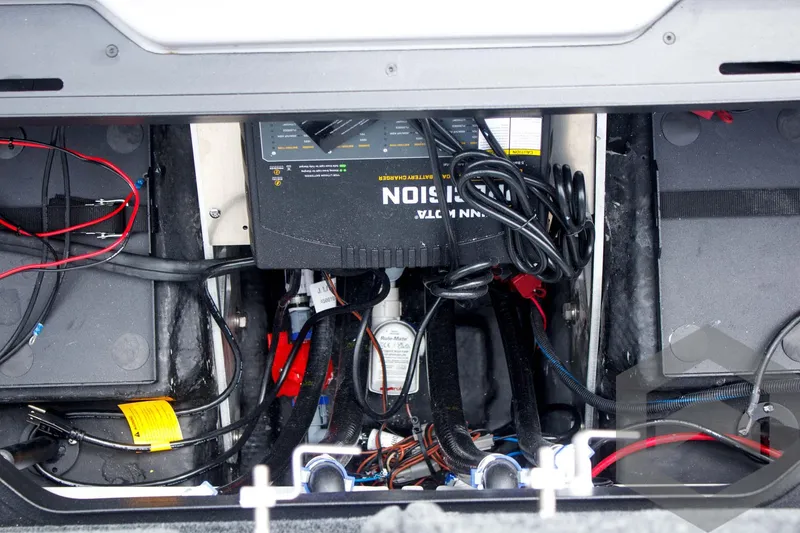 Slide: The Image of Battery compartment of 2025 Skeeter ZXR 21 boat with wiring and charger. - 45
