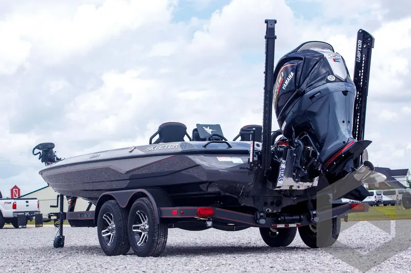 Slide: The Image of 2025 Skeeter ZXR 21 boat on trailer, featuring powerful outboard motor, parked on gravel. - 7